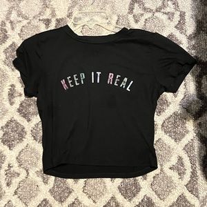 Black crop top “keep it real” writing
